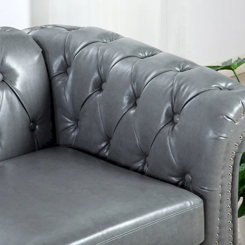 Divano Chesterfield a 3 posti con braccioli arrotolati